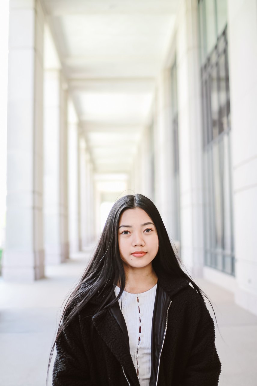 Positive Asian woman in fur coat